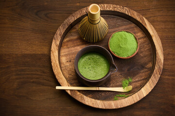 Traditional Matcha Preparation. Close-up of matcha tea in a bowl with a whisk and powder