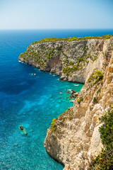 Scenic Zakynthos Greece coastline with steep rocky cliffs green trees and crystal clear blue sea popular holiday destination and instagram view