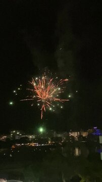 Vertical video. Fireworks on the beach to celebrate the end of the fiesta. Many charges fly up to a small height with high intensity. Mallorca Island. Spain.
