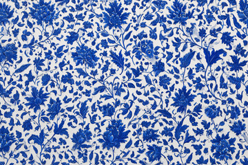 Blue and white floral pattern design on a textured surface