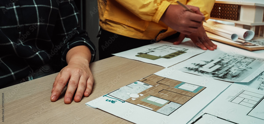 Aufkleber two individuals engage in a dynamic discussion at a modern workspace, analyzing detailed architectur