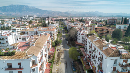 Obraz premium Stock aerial image of an urban city neighborhood with residential buildings, streets and rooftops, created as a resource for real estate, housing and architecture projects. Not a specific location.