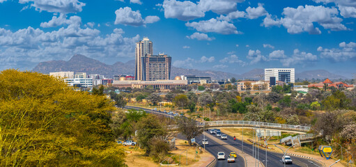 aerial view of Gaborone, main road transport infrastructure bridge flyover, residential with skyscrapers, city road with traffic, African developments