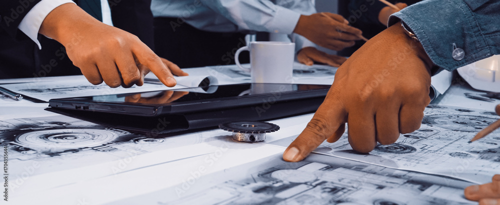 Aufkleber a dynamic business meeting scene features engaged professionals discussing technical blueprints on t