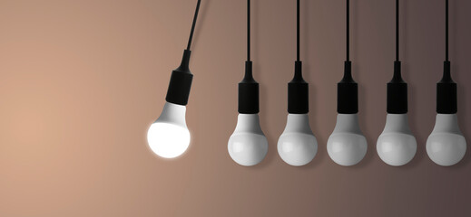 Concept of idea. One glowing light bulb among others on color gradient background. Banner design with space for text
