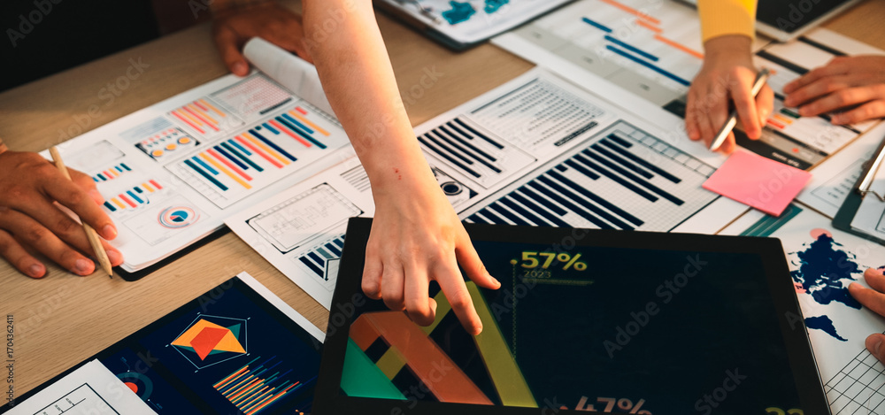 Aufkleber a dynamic workspace captures diverse hands analyzing colorful charts and graphs on a tablet, surroun