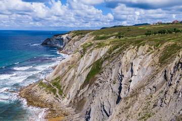 Atlantic coast and ocean. Rocks on the coastline. View from above. Blue sky with clouds. Seascape