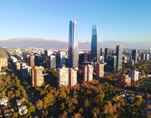 Obraz premium Cityscape panorama of modern buildings and lush trees