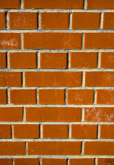 Red brick wall with mortar joints in closeup view