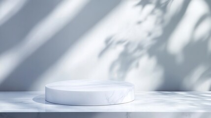 Empty marble display podium with leaf shadow