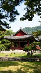 Red-roofed Asian pavilion in a garden setting