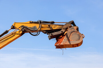 Heavy machinery digs into ground at construction site on works day, during powerful excavation...