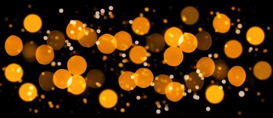 Abstract golden light bokeh on a black background for festive designs