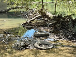 Water pollution tires discarded in a river