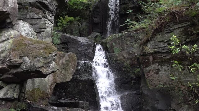 Zoom and pan down of Lumsdale Waterfall, Matlock, United Kingdom. 