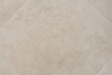 Fototapeta premium Beige ceramic tile with subtle concrete texture, captured top-down showing clean grout lines and modern design. Concept of tile background, ceramic texture, construction material and flooring