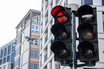 Traffic light displaying red signal against modern urban architecture, highlighting safety and caution in city transportation, emphasizing the importance of road rules and regulations