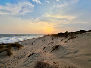 sunset at a coast with dunes near Marbella, view to the Mediterranean Sea, Costa del Sol in the summer, Andalusia, Spain