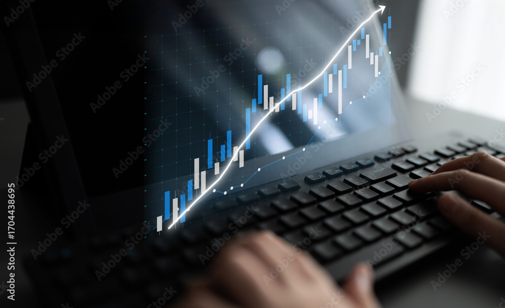 Aufkleber a close-up view of hands typing on a keyboard while interacting with financial data displayed on a s