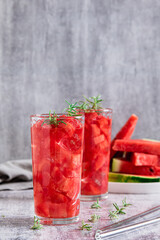 Detox summer drink with watermelon and rosemary in glasses on table vertical view