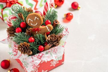 A box with a gingerbread man and pine cones