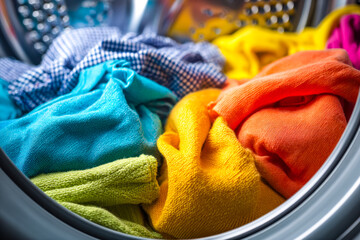 Colorful laundry inside a washing machine drum