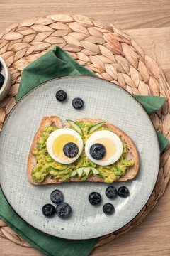 Naklejki A plate of food with a bread face and blueberries
