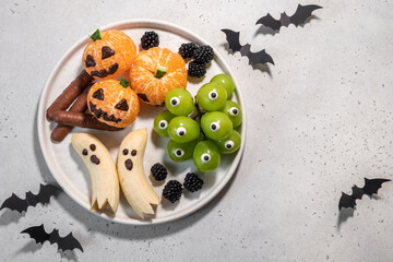A plate of Halloween themed fruit and vegetables