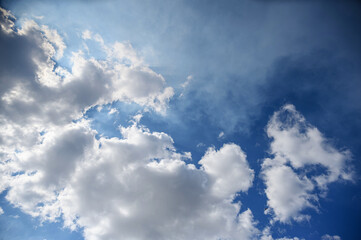 Expansive Blue Sky with Fluffy White Clouds