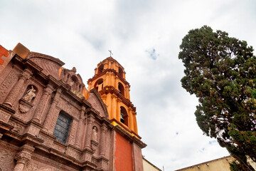 Facade of Oratorio de San Felipe Neri with bell tower and carved stone architecture in San Miguel de Allende