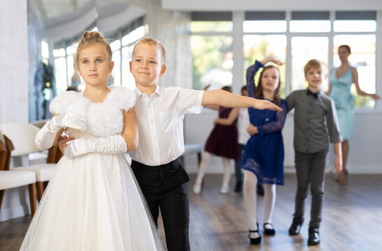 Children dance in pairs at a festive matinee