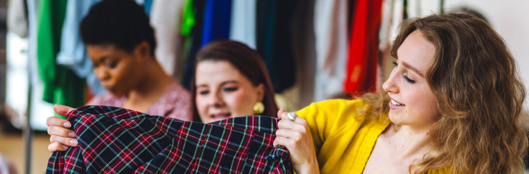 Group of young women creating small modern business start up, project for fashion design, clothes creation. Concept of people at work, purchasing and online shopping. Friends learning, college life - Powered by Adobe