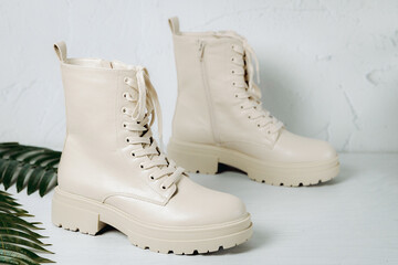 Beige shoes on the floor near the wall.