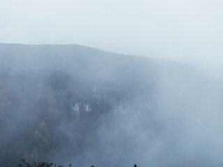 Misty mountain landscape with autumn forest