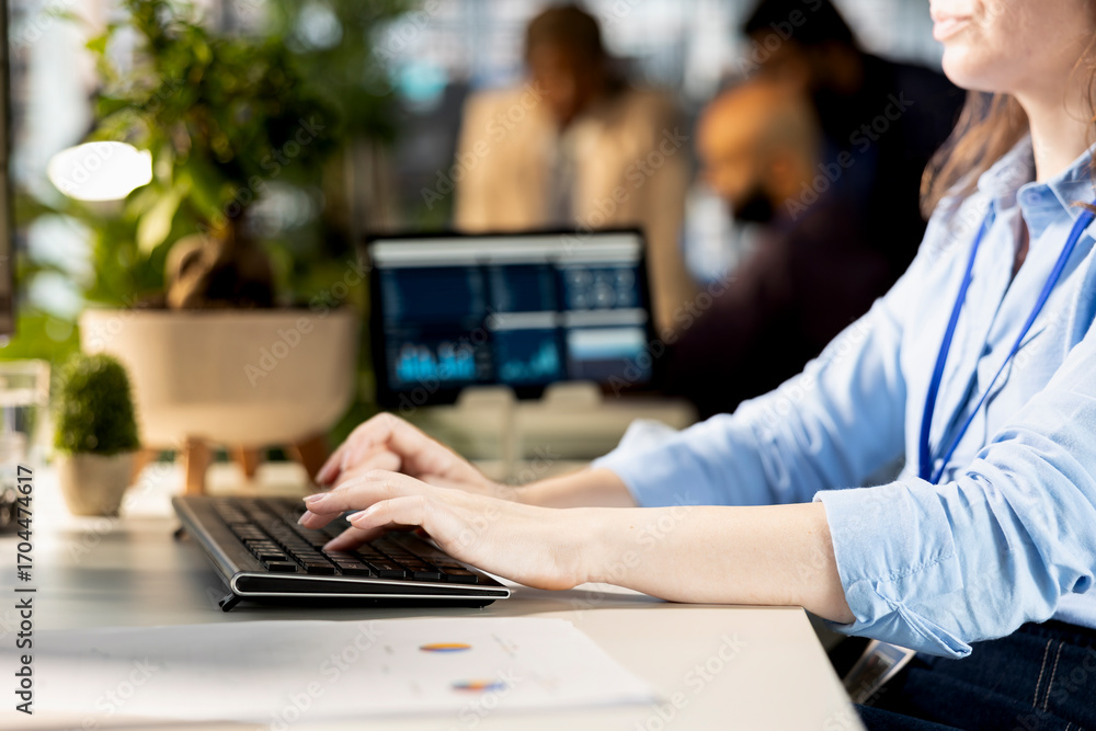 Poster Woman analyst reviewing company data to create a new strategy and plan an expansion, handling resource allocation and effective business operations. Expert does financial forecasting.
