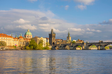 Charles Bridge (Karluv Most) on Vltava river and Old Town Bridge Tower, famous tourist destination in Prague, Czech Republic (Czechia), at sunset