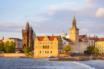 View of old town with Charles Bridge (Karluv Most) on Vltava river and Old Town Bridge Tower, famous tourist destination in Prague, Czech Republic (Czechia), at sunset