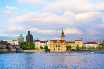 View of old town with Charles Bridge (Karluv Most) on Vltava river and Old Town Bridge Tower, famous tourist destination in Prague, Czech Republic (Czechia), at sunset