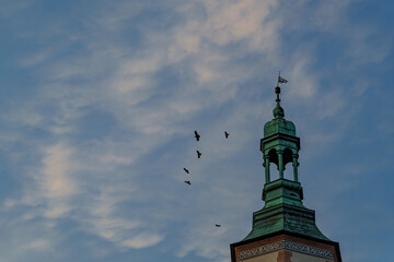 Tower and Birds Against Blue Sky