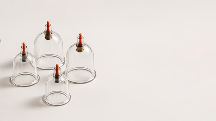 Clean white background highlights transparent glass cupping therapy tools. Wellness and alternative medicine concept for holistic healing. Hijama, treatment according to the Sunnah.