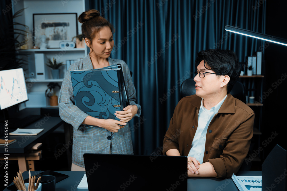 Poster serious face of working sales manager with secretary taking overworked folder paper at over late nig