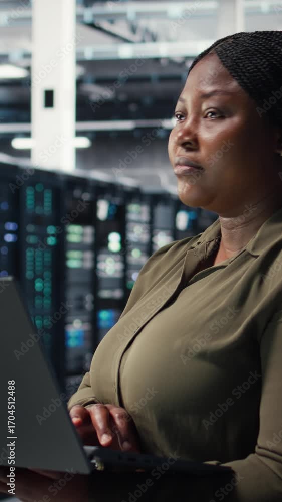 Aufkleber vertical video data center workplace programmer using laptop to coordinate deployment of new server 