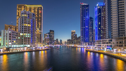 Obraz premium Dubai Marina towers and canal in Dubai day to night timelapse