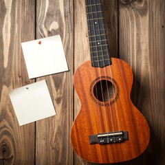 Ukulele on wooden background