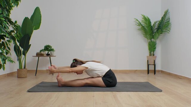 High-definition footage of a female instructor performing a variety of full-body yoga poses on a bright, neutral backdrop. Clean, minimalist composition and soft studio lighting highlight balance, fle