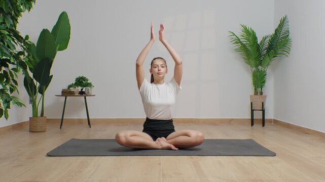 High-definition footage of a female instructor performing a variety of full-body yoga poses on a bright, neutral backdrop. Clean, minimalist composition and soft studio lighting highlight balance, fle