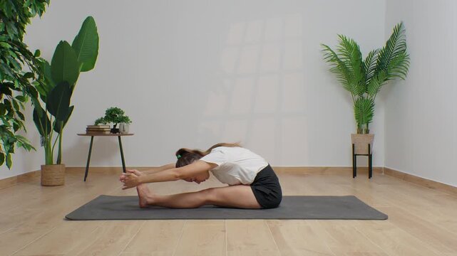 High-definition footage of a female instructor performing a variety of full-body yoga poses on a bright, neutral backdrop. Clean, minimalist composition and soft studio lighting highlight balance, fle