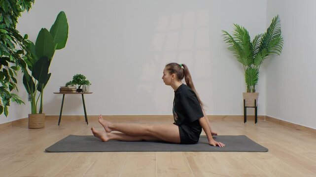 High-definition footage of a female instructor performing a variety of full-body yoga poses on a bright, neutral backdrop. Clean, minimalist composition and soft studio lighting highlight balance, fle