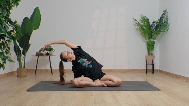 High-definition footage of a female instructor performing a variety of full-body yoga poses on a bright, neutral backdrop. Clean, minimalist composition and soft studio lighting highlight balance, fle