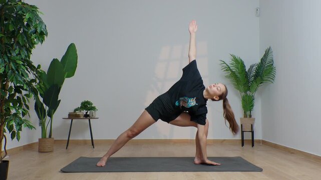 High-definition footage of a female instructor performing a variety of full-body yoga poses on a bright, neutral backdrop. Clean, minimalist composition and soft studio lighting highlight balance, fle
